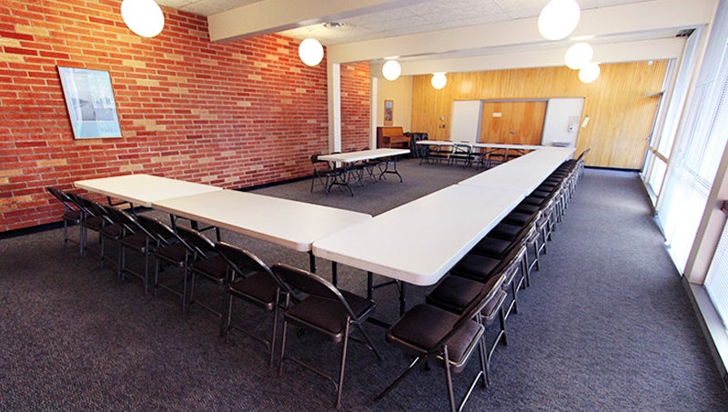 Tables and chairs arranged in a U shape for easier group interactions or discussions.