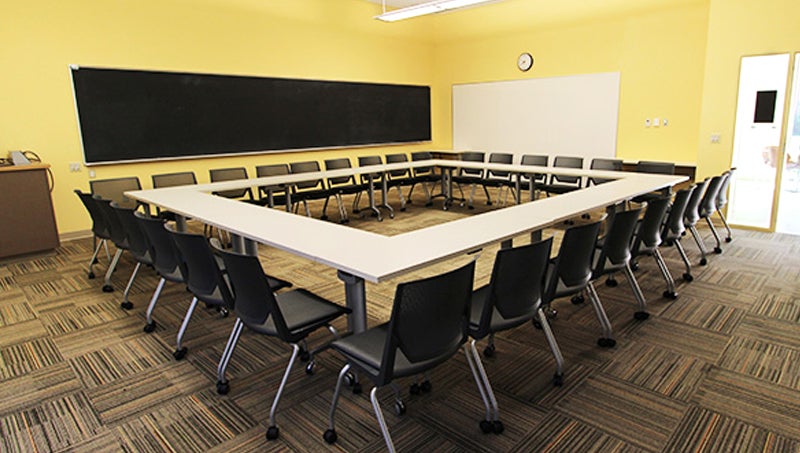 Tables and chairs arraynged in a O shape or a hollow square shape for easier group discussions.