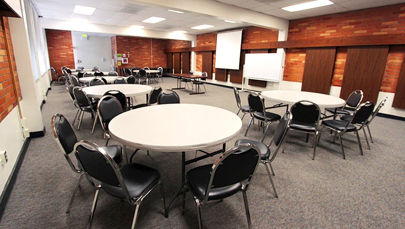 Round tables setup with approximately 5 chairs per table, helps with small groups or if meals are served.